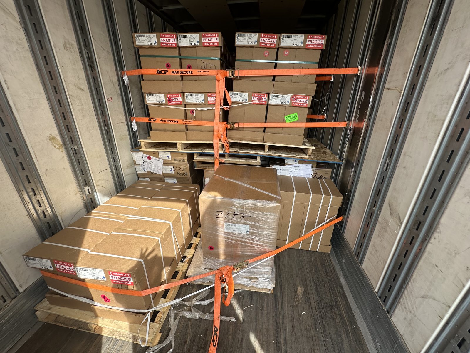 Palletized freight secured with high-visibility ratchet straps