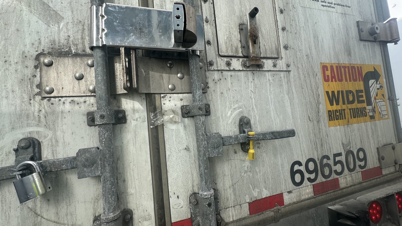 Padlock and high-security lock on trailer door hasp